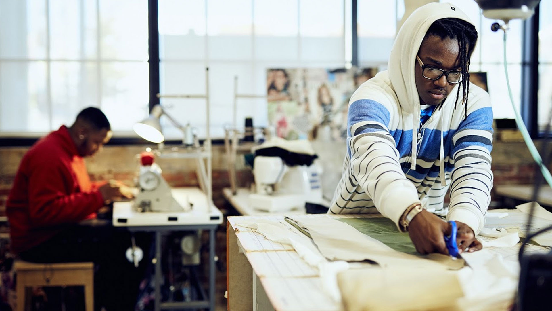 Fashion design student cutting a pattern at Baltimore Design School